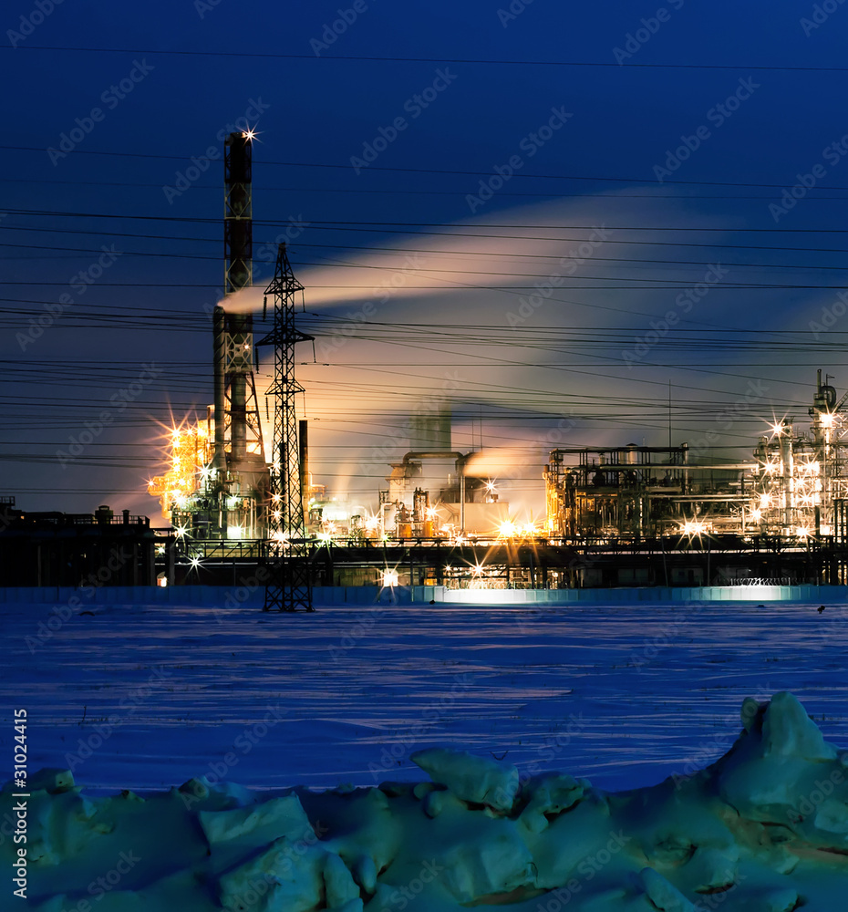 Lighted refinery  in the evening after sunset