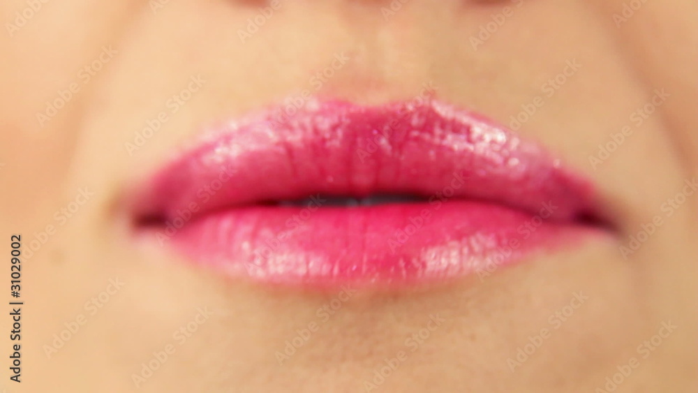 Woman's tongue seductively licking lips, close up Woman's tongue seductively licking lips, close up