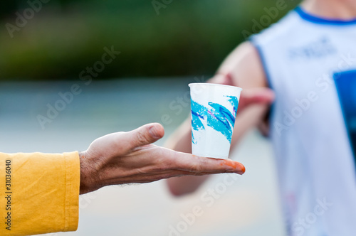 Hand with water in marathon