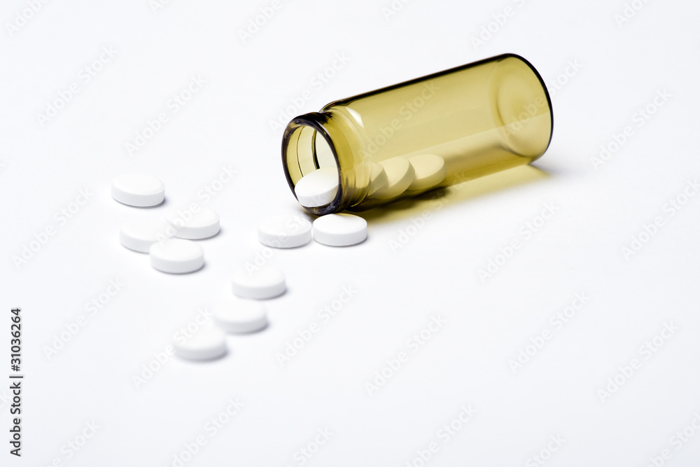 Pills and container on white background Pills and container on white background