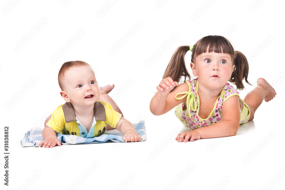 Little boy and girl lying on white Little boy and girl lying on white