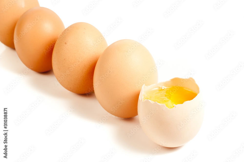Five eggs standing, one cracked On white background Five eggs standing, one cracked On white background