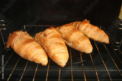 Fresh French croissants in oven
