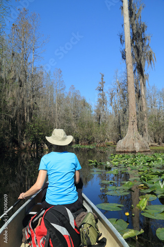 Woman Paddling a Canoe through the Okefenokee Swamp National Wildlife Refuge - Georgia © Brian Lasenby