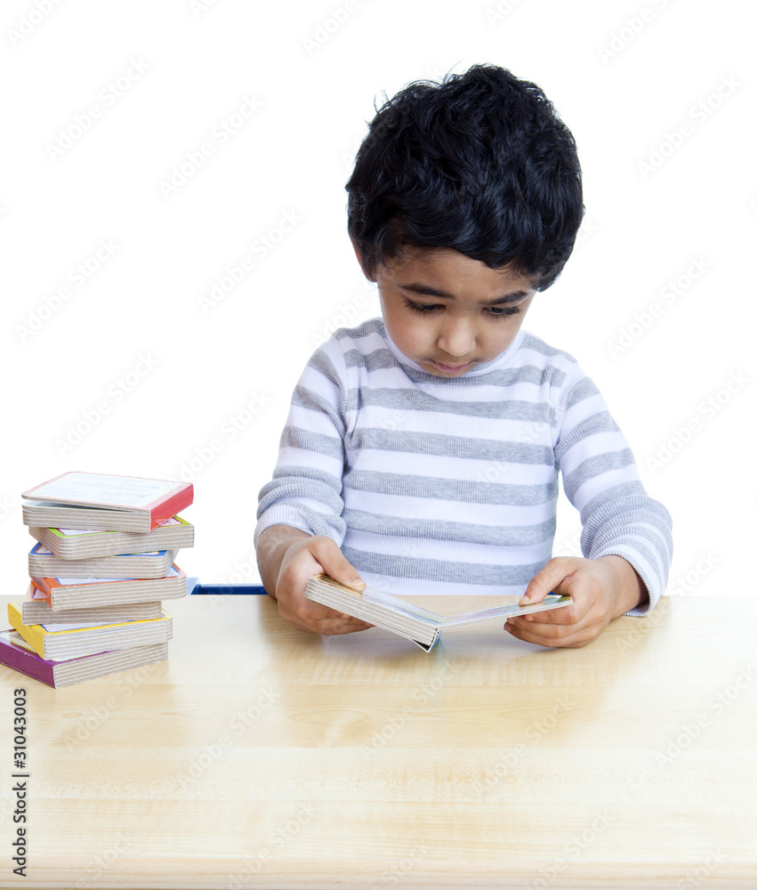 Preschooler Engrossed in Reading Picture Books Preschooler Engrossed in Reading Picture Books