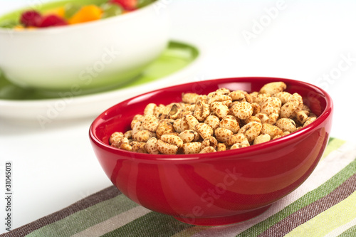 Puffed wheat cereal in red bowl