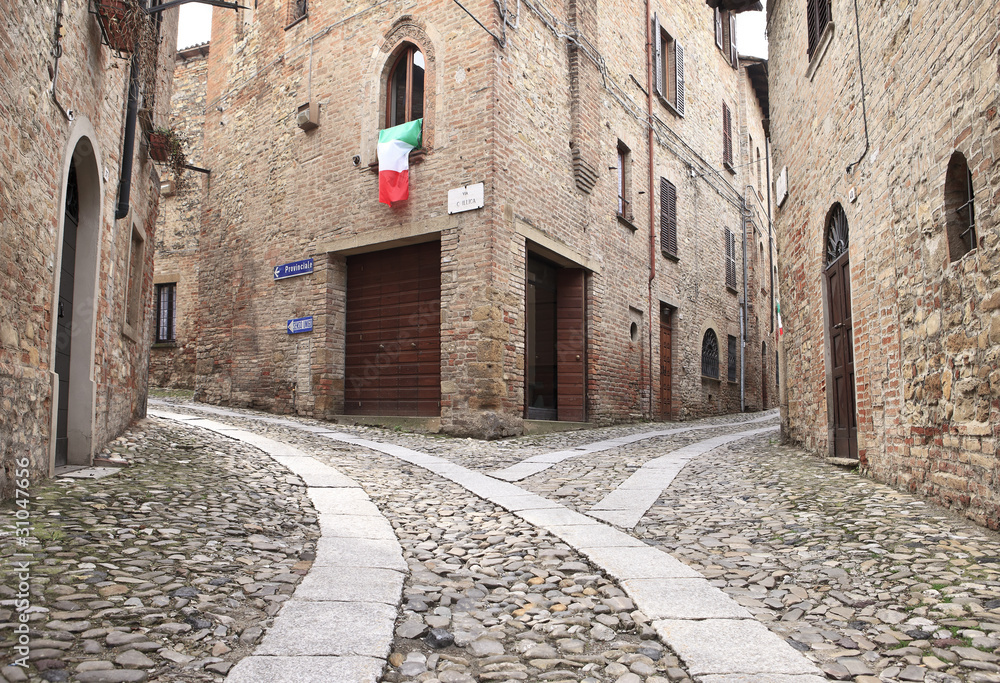 Old terraced houses on cobbled alleyway, Castell'Arquato