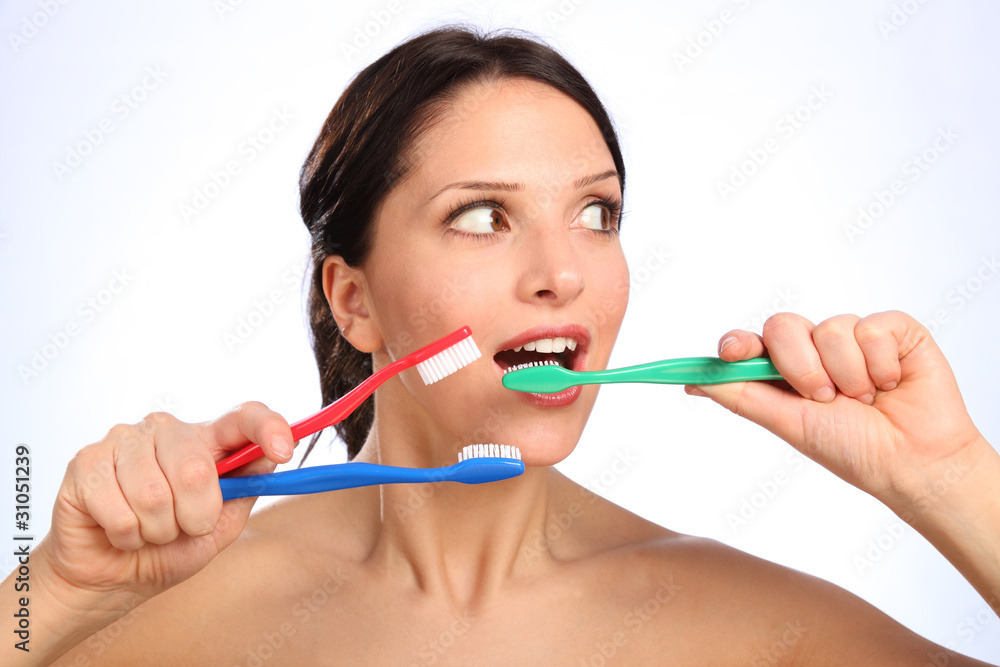 Fun young woman with three toothbrushes Fun young woman with three toothbrushes