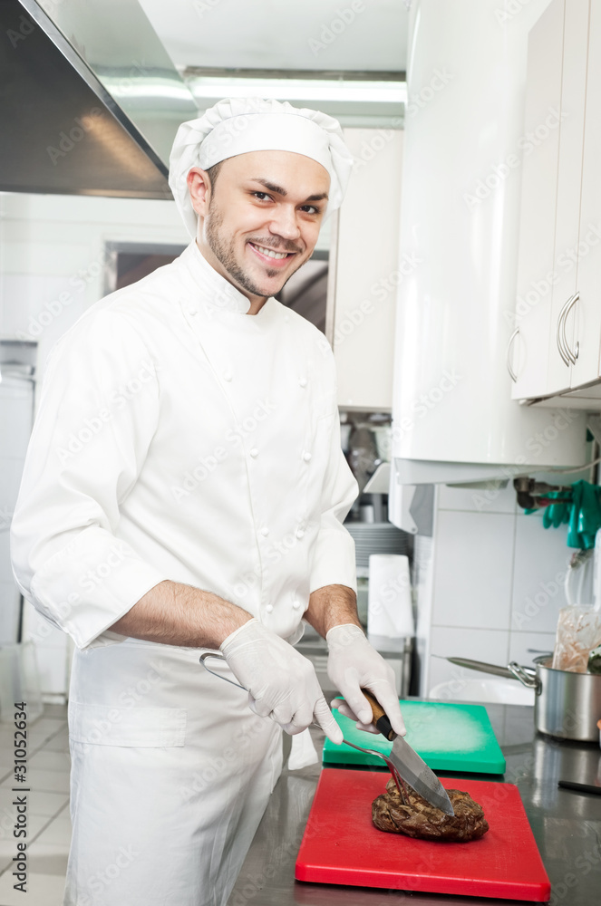 chef cutting beef steak on board chef cutting beef steak on board