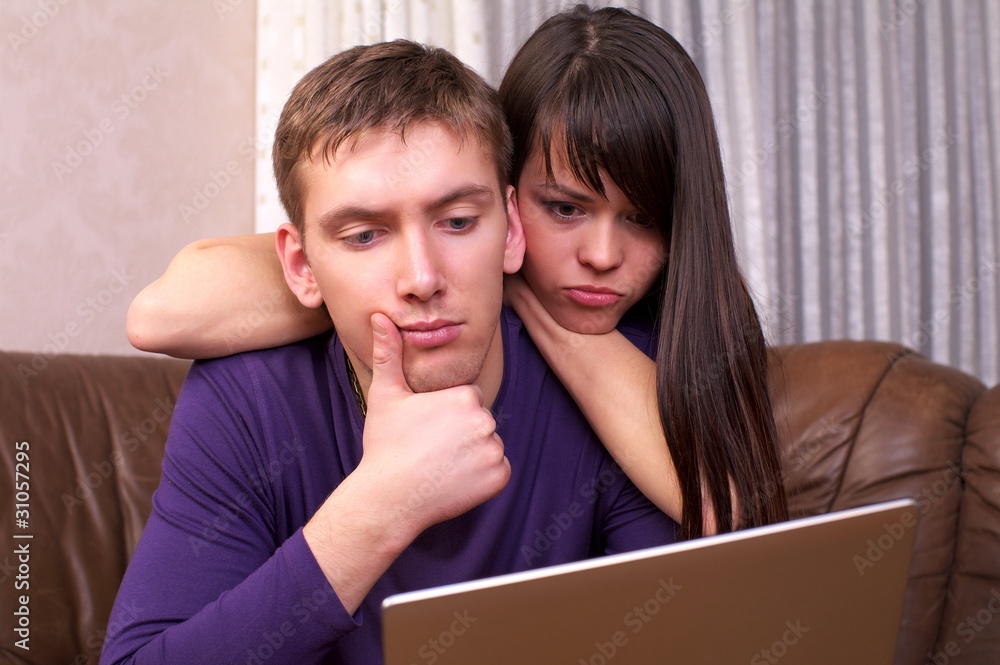 Young couple using a laptop Young couple using a laptop
