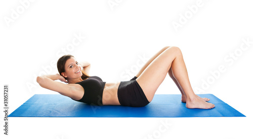 Fitness woman doing crunches on gym mat