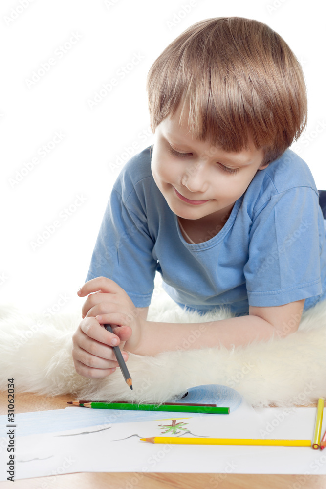 Cute dreaming child lies and draw on soft sheep fur Cute dreaming child lies and draw on soft sheep fur