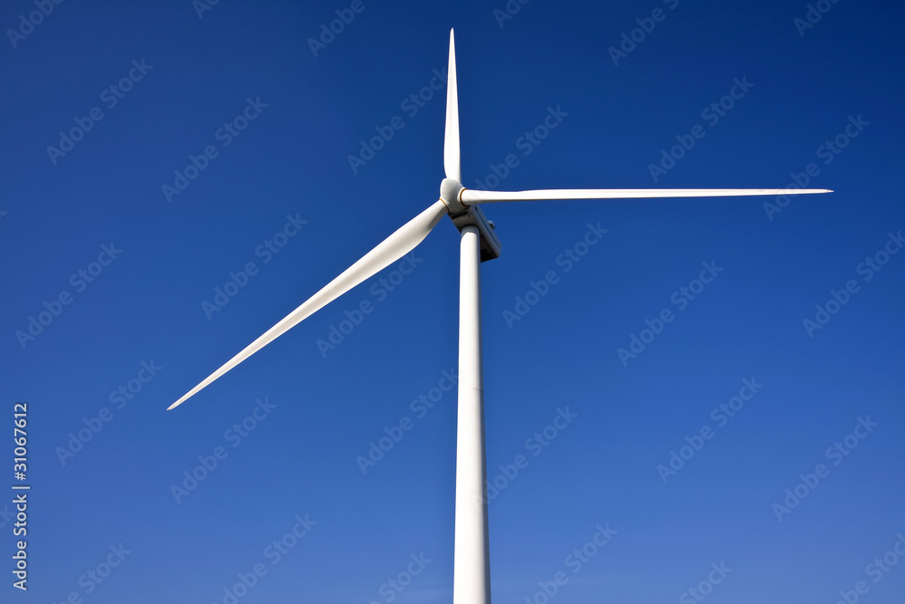 white wind turbine generating electricity on blue sky white wind turbine generating electricity on blue sky