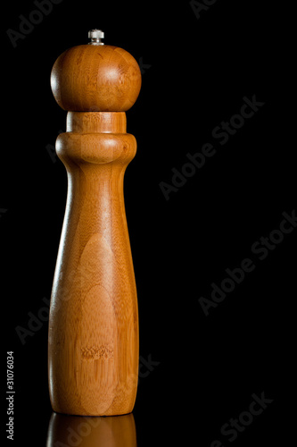 Wooden salt or pepper grinder photo