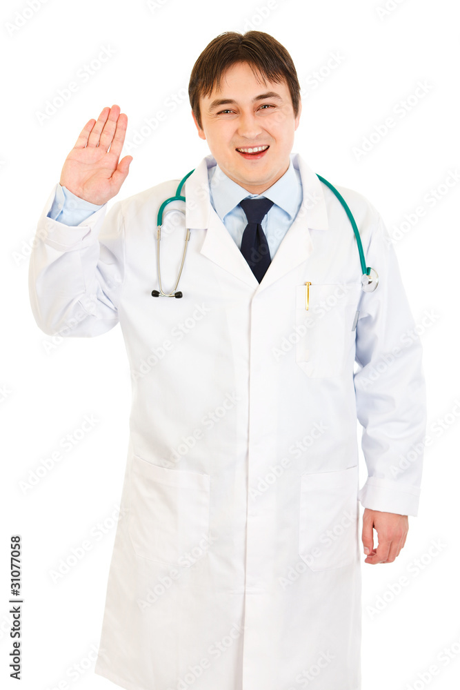 Smiling doctor showing salutation gesture isolated on white. Smiling doctor showing salutation gesture isolated on white.