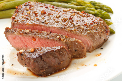 Grilled steak with Green asparagus on white background