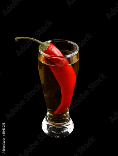 Cocktail with chilli pepper isolated on black photo