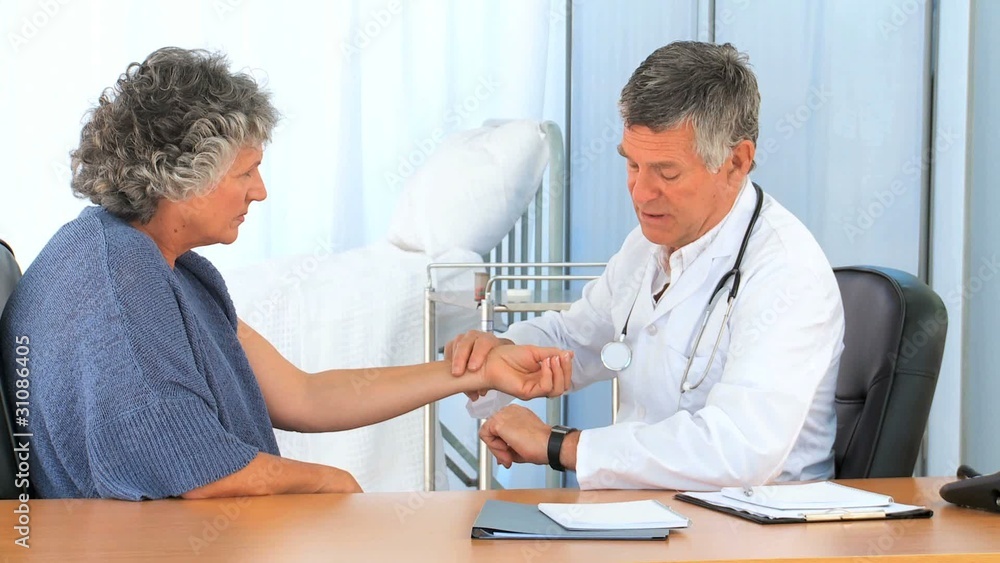 Doctor taking the pulse of his patient Doctor taking the pulse of his patient