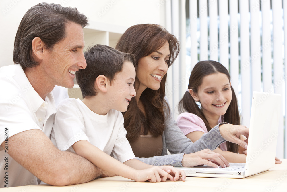 Family Sitting Using Laptop Computer At Home Family Sitting Using Laptop Computer At Home