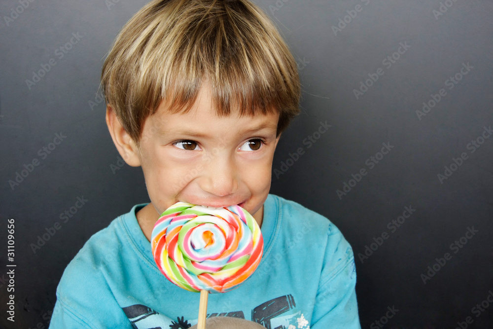 young boy with colorful lollipop