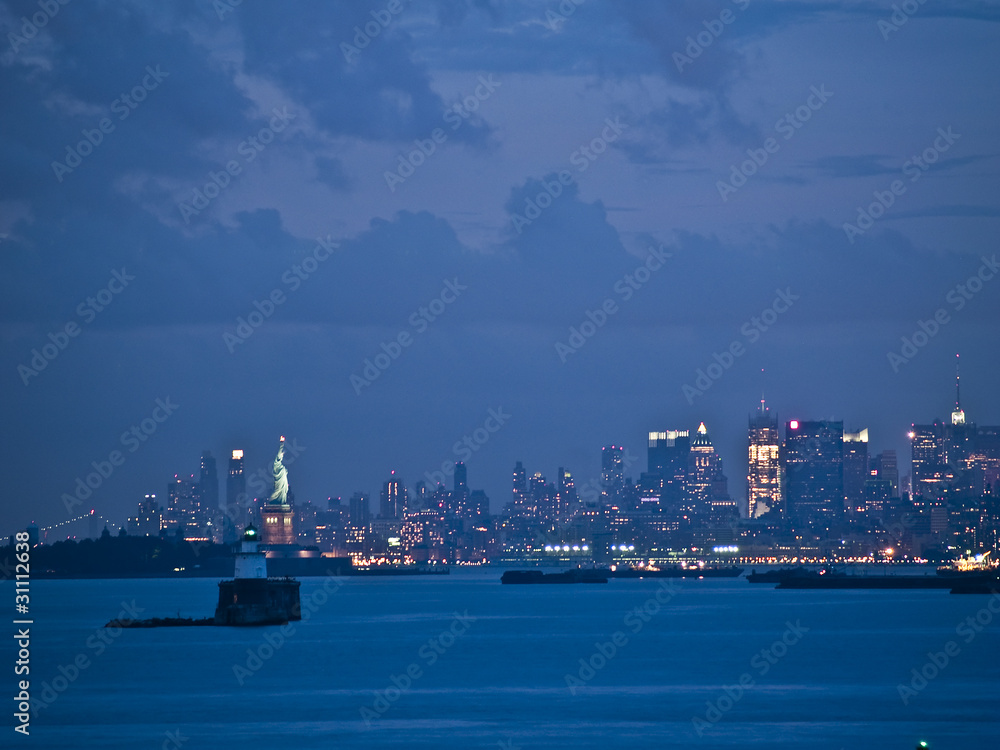 New York City Skyline  and Statue of Liberty at dusk