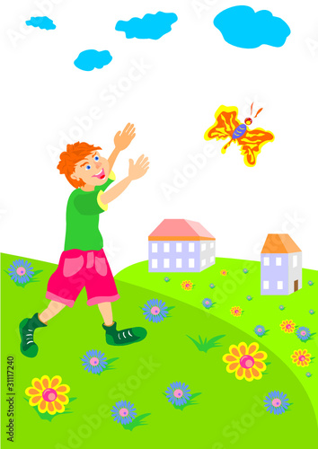 boy runs across the field after a butterfly