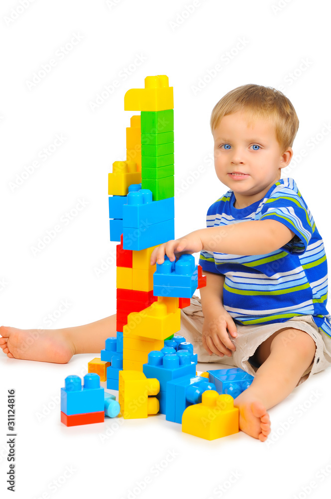 Cute little boy is playing with building blocks Cute little boy is playing with building blocks
