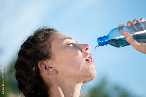 Beautiful woman drinking water. Thirst