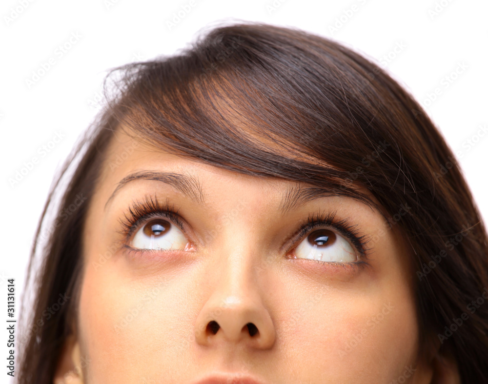 The girl looks upwards on a white background The girl looks upwards on a white background