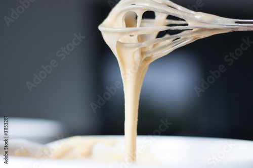 Batter dripping from whisk