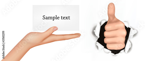 Hand with thumb up has broken through a paper and hand with card