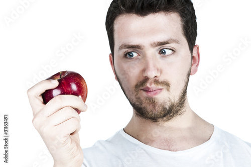 Young man straing at an apple