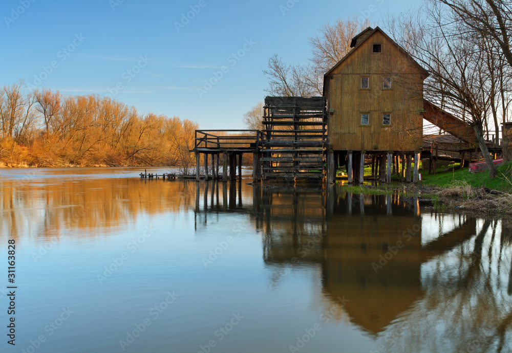 Historic wooden watermill with reflection. Historic wooden watermill with reflection.