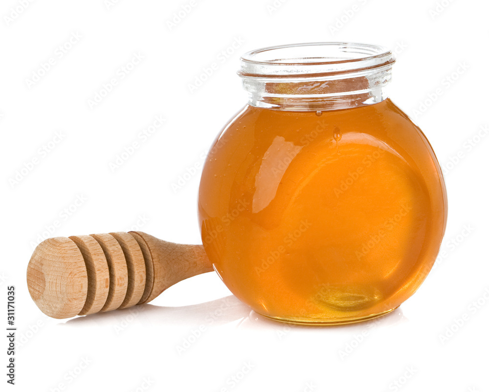 glass pot full of honey isolated on white glass pot full of honey isolated on white