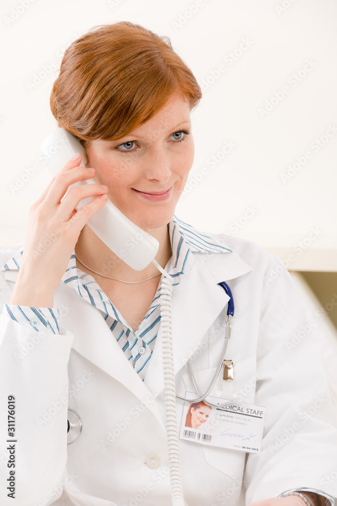 Doctor office - female physician make phone call Doctor office - female physician make phone call
