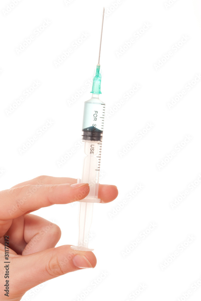 A close up of a hand holdind a syringe A close up of a hand holdind a syringe