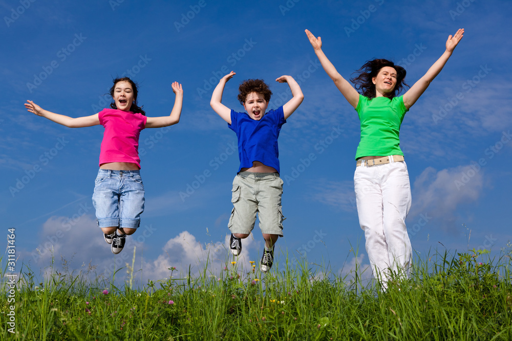 Active family - mother and kids jumping outdoor Active family - mother and kids jumping outdoor
