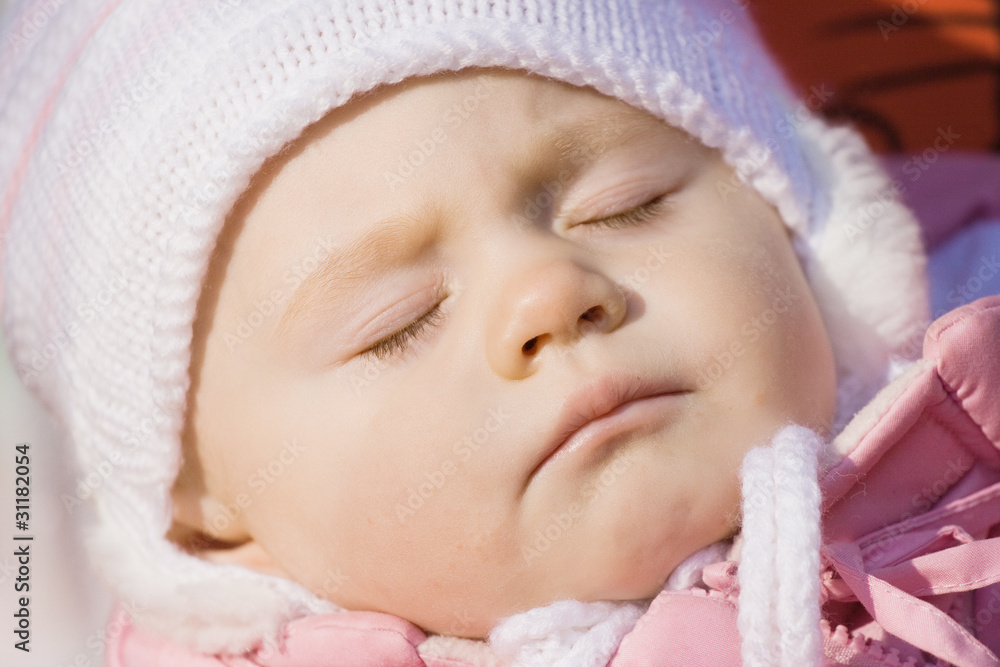 little girl in a pink jacket sleeps in a carriage little girl in a pink jacket sleeps in a carriage