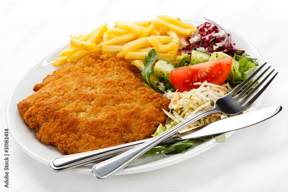 Pork chop, French fries and vegetables Pork chop, French fries and vegetables
