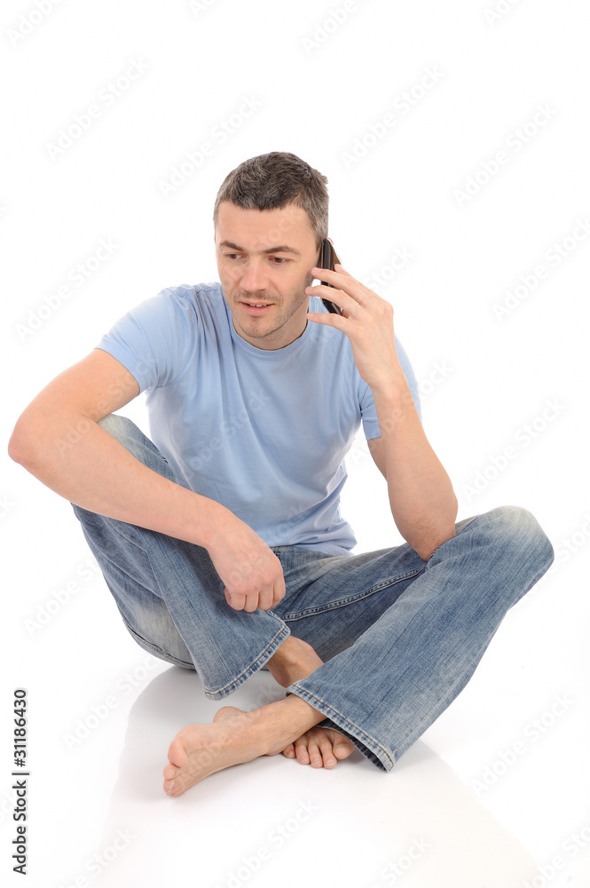 casual young man speaking on the mobile phone. isolated casual young man speaking on the mobile phone. isolated
