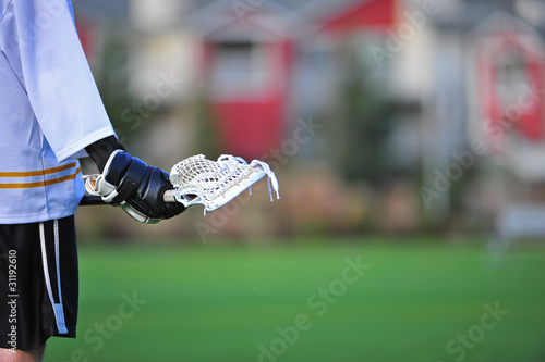 Schilderij op canvas Boys lacrosse player holding stick