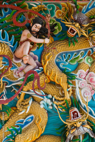 Chinese god fight to the dragon on temple wall, Thailand