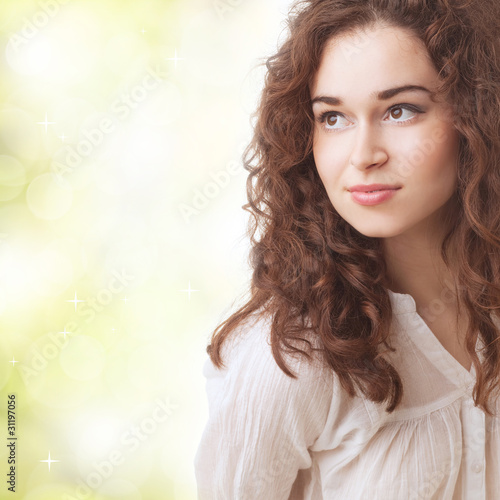 Beautiful young woman against abstract nature background