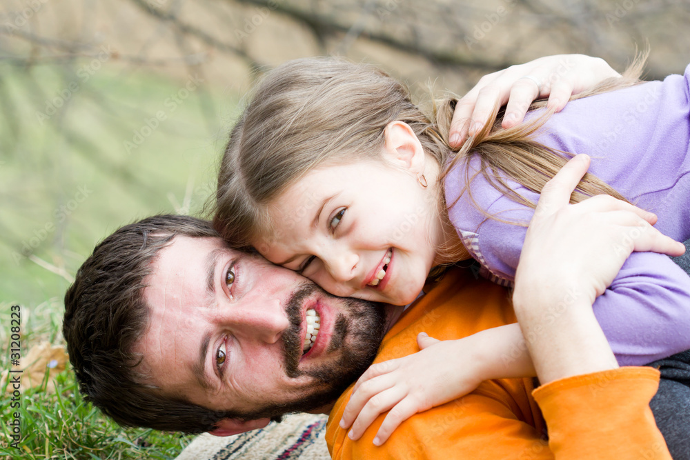 Father playing with his daughter in the park Father playing with his daughter in the park