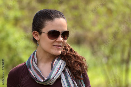 Young woman in the park with sunglasses