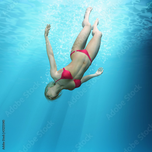woman diving in the deep sea