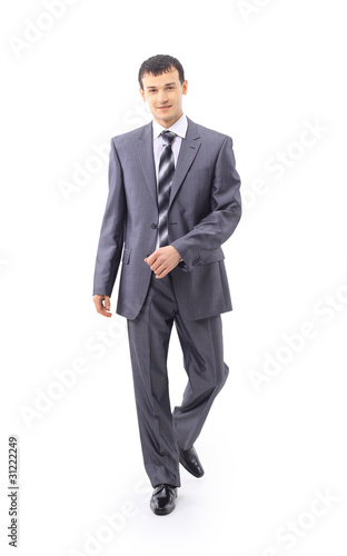 Portrait of a confident young male entrepenuer walking photo