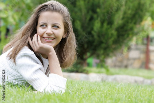 young happy woman resting on natural background