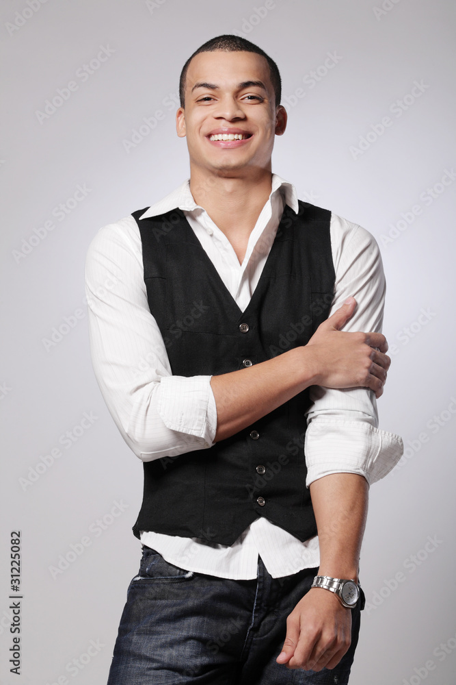 Stylish young fashion male model on gray background. Stylish young fashion male model on gray background.
