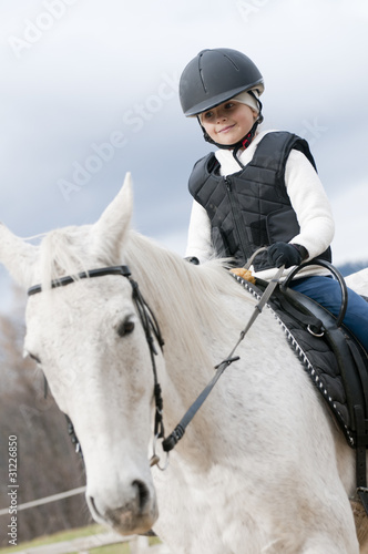 Horse riding - little girl is riding a horse